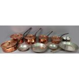 A collection of ten copper and tin lined cooking pans, several detailed 'Peter Brux',
