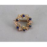 A gold, sapphire and seed pearl set wreath brooch,