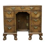 An early 18th century and later cross and feather banded kneehole desk,