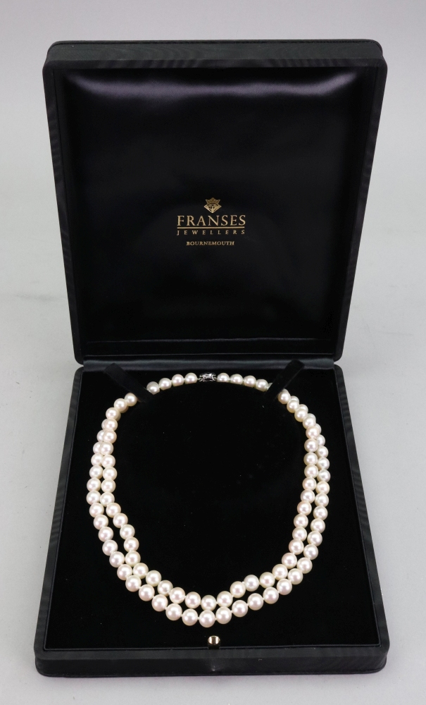 A double row necklace of uniform cultured pearls, complete with 18ct white gold oval snap clasp,