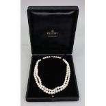 A double row necklace of uniform cultured pearls, complete with 18ct white gold oval snap clasp,
