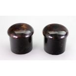 A pair of cylindrical tortoiseshell jars, circa 1920's, with screw off domed covers, 7cm high.