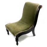 A late Regency ebonised gilt metal mounted slipper chair, upholstered in green velour,