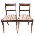 A set of four Regency faux rosewood dining chairs, with curved top rails and bar backs,