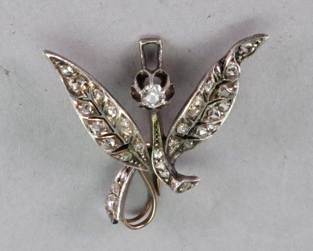 A silver diamond flower spray pendant, set throughout with old and rose cut diamonds,