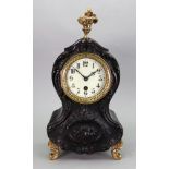 A Louis XV style ebonised gilt metal mounted mantel timepiece, late 19th Century, of shaped outline,