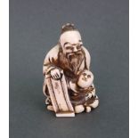 A Japanese ivory netsuke, carved as a sa