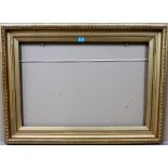 A 19th century gilt plaster frame, with egg and dart moulding, aperture 52cm x 77cm.