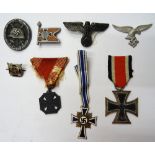 A small group of eight mostly German Third Reich medals and insignia, including an iron cross,