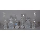 Three glass spirit decanters and stoppers, a pair of globe and shaft decanters and stoppers,