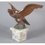 A polychrome painted bronze eagle, circa 1930, signed 'M. Decoux' on an onyx plinth, 35.
