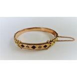 A 9ct gold, sapphire and diamond set oval hinged bangle,