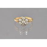 A gold and diamond set seven stone cluster ring, mounted with cushion shaped diamonds,