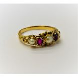 A gold, ruby and cultured pearl ring, mounted with two cushion shaped rubies,