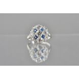 A diamond and sapphire cluster ring, collet set with five principal cushion shaped diamonds,