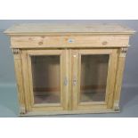 An early 20th century pine side cabinet with fluted edges,