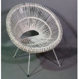 A mid-20th century white painted rattan low armchair.