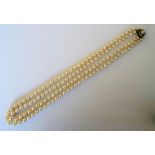 A two row necklace of graduated cultured pearls, on a gold,