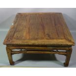 An early 20th century Chinese hardwood low table on block supports, 98cm wide x 54cm high.