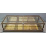 An early 20th century oak and glass table top display cabinet, 145cm wide x 36cm high.