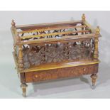 A Victorian walnut three division Canterbury with fret cut decoration and single drawer to base,
