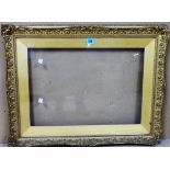 A 19th/ 20th century gilt plaster swept frame and slip, glazed aperture, 37cm x 54cm.