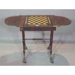 A George IV rosewood combination drop flap games table, 52cm wide x 71cm high.