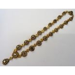 A gold and silver set rose diamond necklace, designed as a row of graduated flowerhead shaped links,