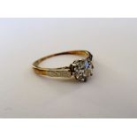 A gold and diamond single stone ring,