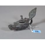 An unusual bronze oil lamp, the hinged lid in the form of a bird, 14cm wide.