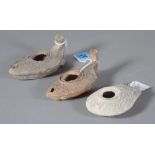Three Roman style terracotta oil lamps, the largest 12cm wide, (3).