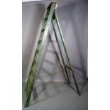 An early 20th century green painted eight rung 'A' frame ladder, 210cm high.