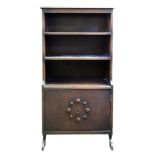 An oak dwarf bookcase with cupboard under, 66cm wide, 22cm deep, 122cm high.