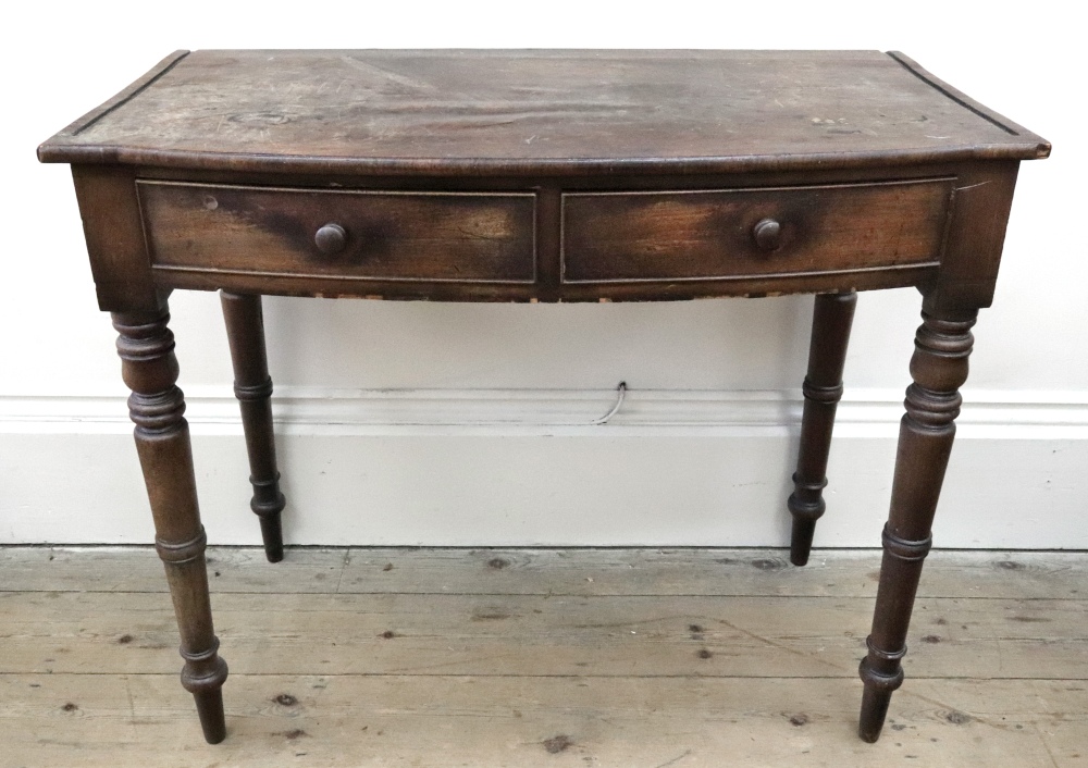 A late Regency mahogany bowfront two drawer dressing or writing table,