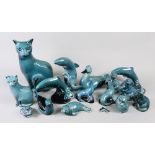 A collection of sixteen dolphin blue Poole Pottery figures of animals including two cats,