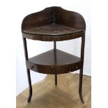 A George III mahogany ebony strung bowfront corner washstand, 61cm wide, 43cm deep, 105cm high.