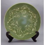 A Poole Pottery dish, 1980's, foliate decorated on a mottled green shaded ground, 34.5cm diameter.