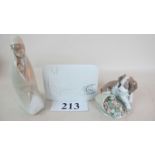 Three Lladro models, depicting a kneeling mother and infant, a puppy knocking over a plant pot,