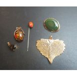A leaf dipped pendant, two other pendants,