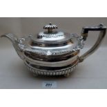 A Georgian silver teapot on ball feet with 1/2 fluting shell decoration and acanthus leaf decorated