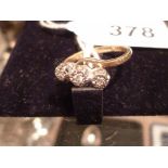 An 18ct gold three diamond cross over ring (size O) est: £100-£130