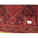 A mid 20th century Persian rug on claret ground with central medallion and stylised animals (250 x