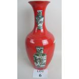 A Chinese porcelain vase, 20th century, decorated with enamel vases on a red ground,