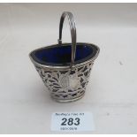 A small silver 19th century dish with swing handle and pierced and engraved decoration blue liner