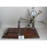 An antique brass and steel wool winder, on mahogany plinth base,70 cm wide,