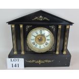 A 19th century black marble cased mantel clock of Romanesque architectural form,