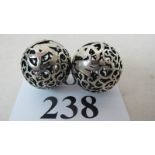 A pair of Chinese white-metal worry balls, pierced dragons, impressed marks,