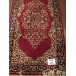 A 20c small Persian design rug on red ground (160 x 84 cm approx) est: £40-£60