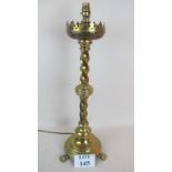 An ornate large brass table lamp in an ecclesiastical taste, cast iron weighted base,