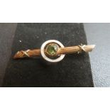 A 9ct gold peridot and enamelled set brooch est: £25-£45